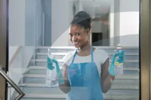 Ask Cindy Shop, a woman cleaning a window with a towel and glass cleaner