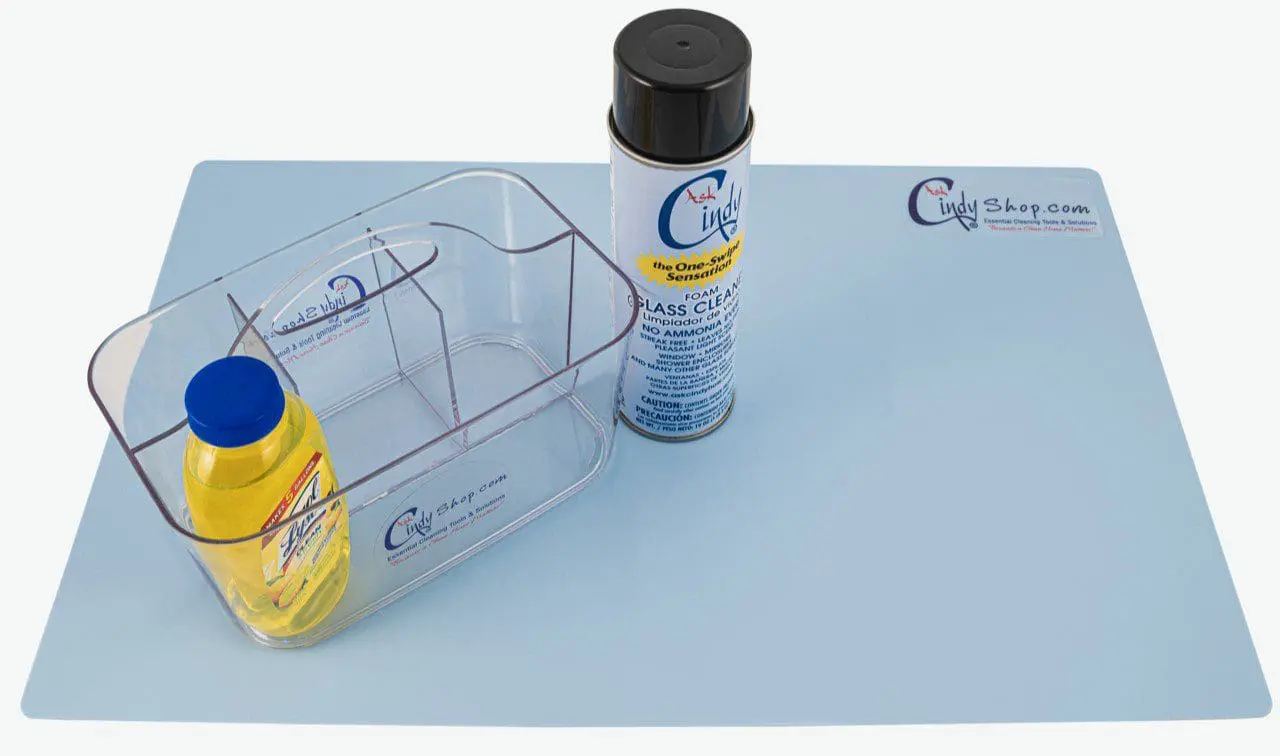 Two bottles of cleaning materials on a utility mat