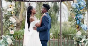 Beautiful african American bride and groom smiling and dancing together