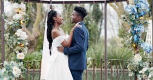 Beautiful african American bride and groom smiling and dancing together